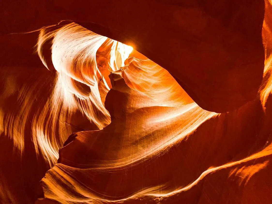 Beam of light piercing the glowing amber sandstone of Antelope Canyon — Arizona fine art print