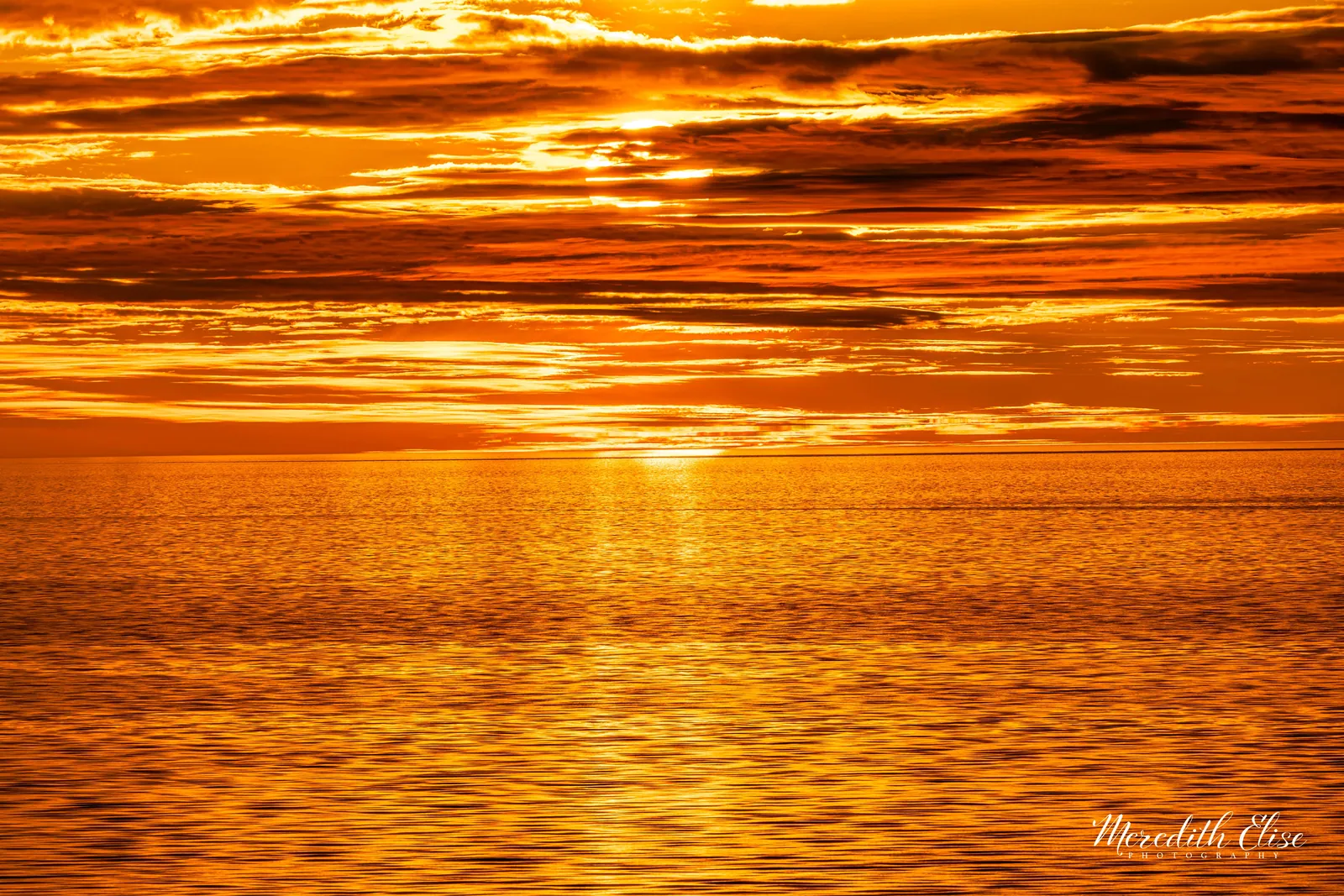 Midnight sun burning through layered clouds over golden Arctic waters — Northwest Passage fine art print