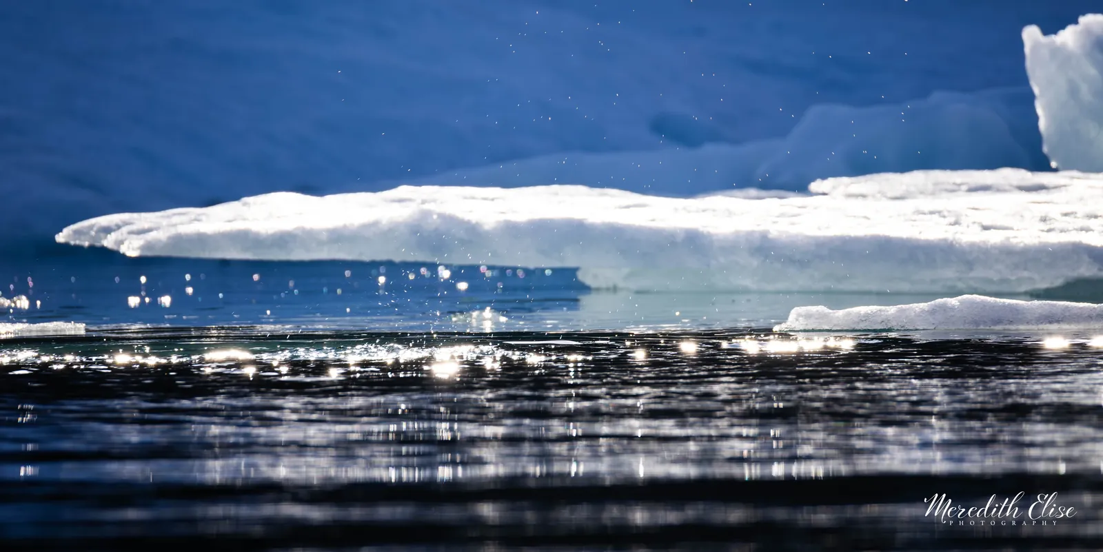 Sunlit ice floe sparkling above dark rippled Arctic water — Northwest Passage fine art print