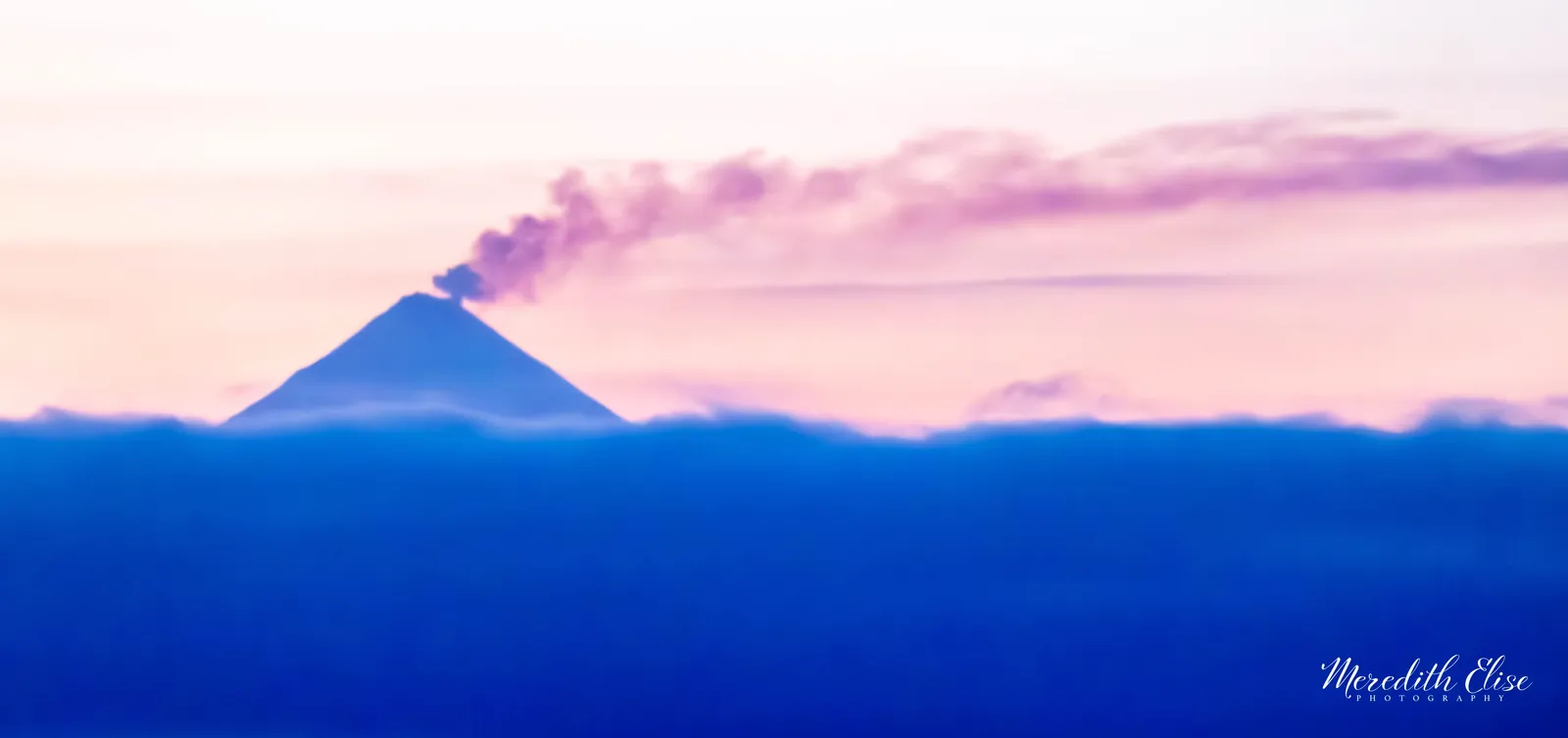 Shishaldin Volcano venting steam at dawn above a deep blue cloud bank — Unimak Island Aleutian Islands Alaska fine art print