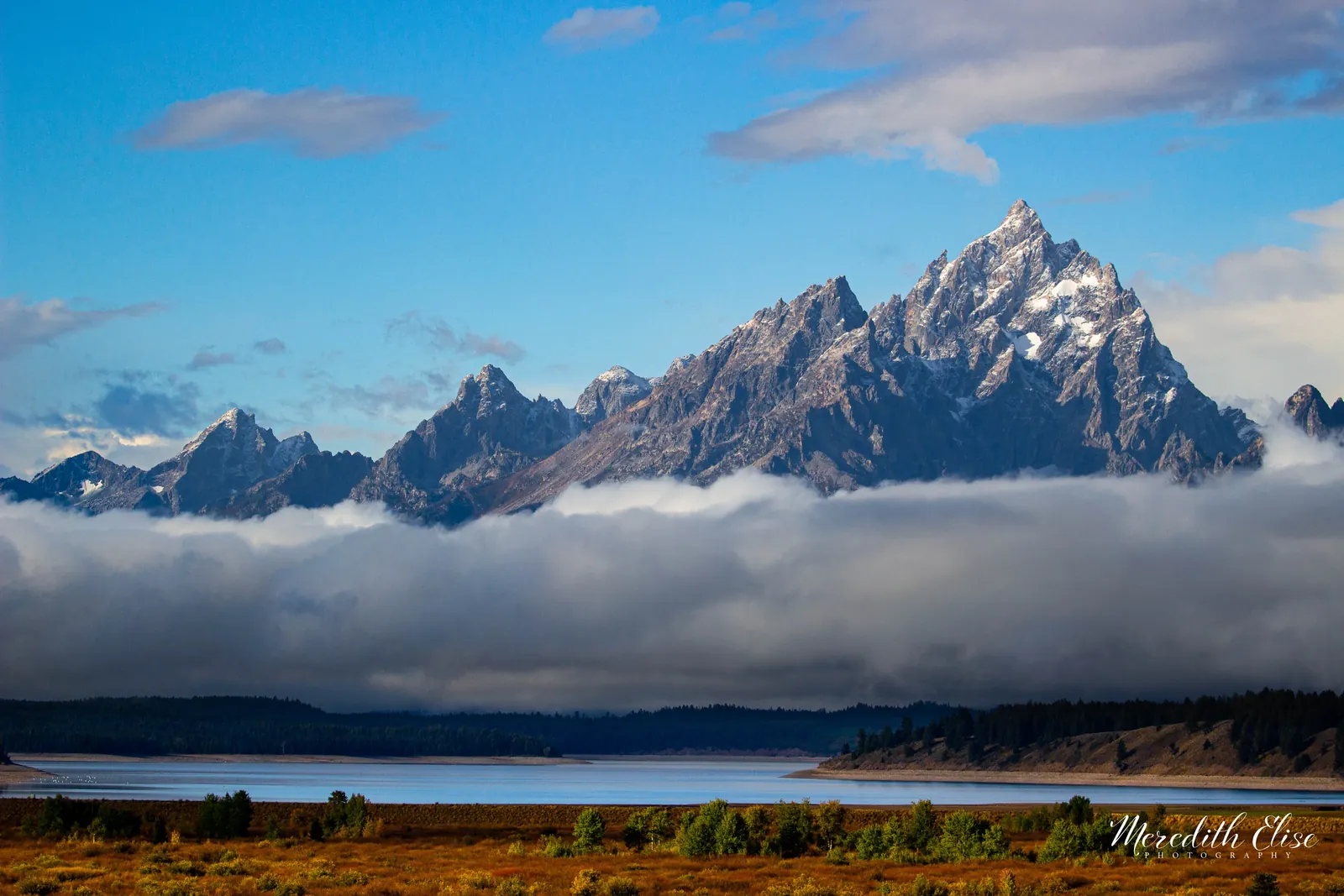 Grand Teton rising above a low bank of clouds with Jackson Lake below — Wyoming fine art print