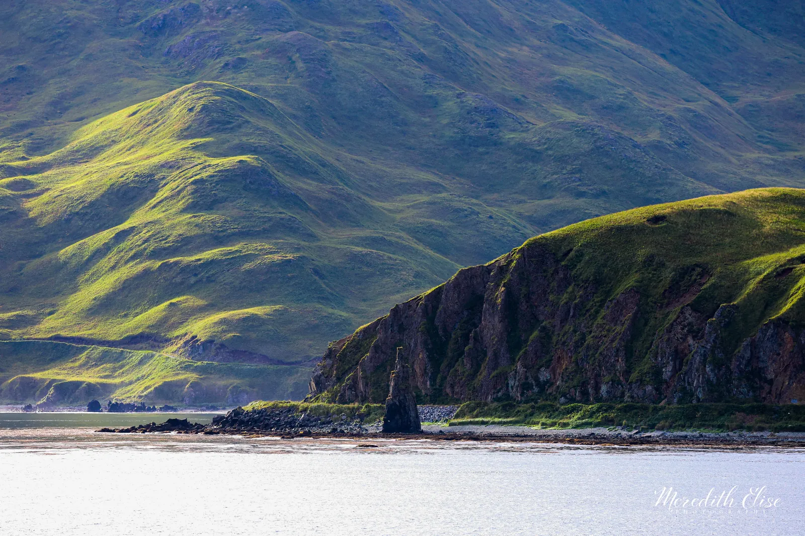 Early light raking across green treeless hills and sea stacks of Unalaska — Aleutian Islands Alaska fine art print