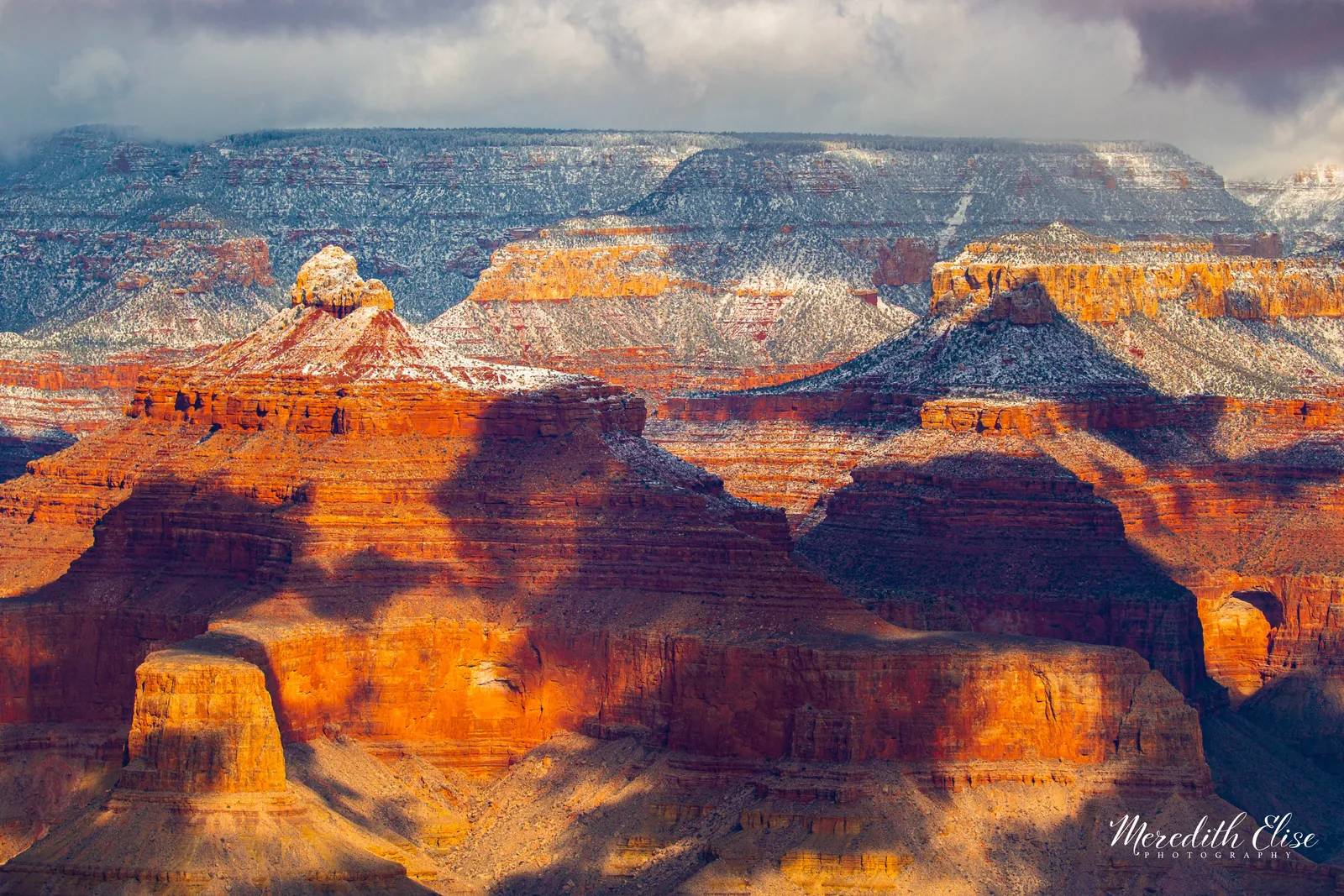 Snow-dusted buttes and glowing red rock inside the Grand Canyon in winter — Arizona fine art print